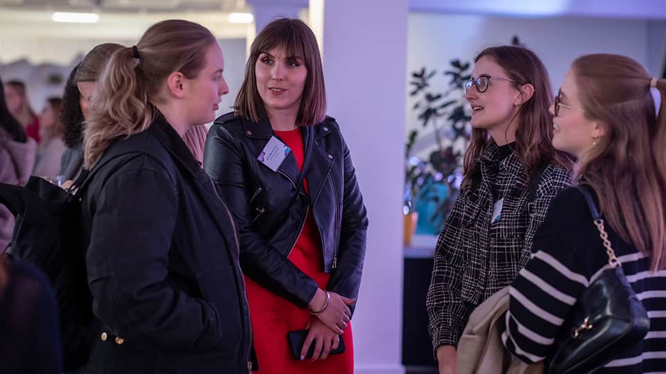 A group of alumnae chatting at an event