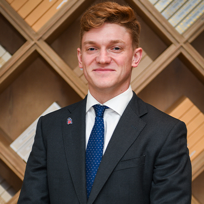 Charlie Williams in a suit smiling