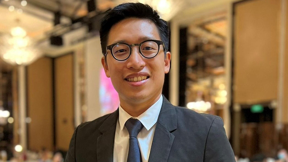 Headshot of Dominic Low smiling