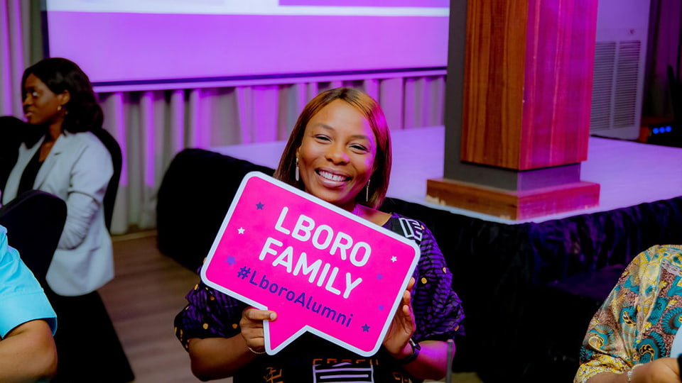 Person holding a pink Lboro Family sign