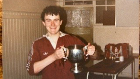 an old image of Steve Reid holding an cup