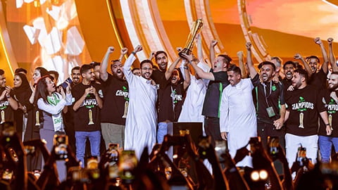 Team Falcons lifting a trophy