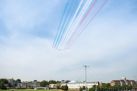 The Red Arrows flying over the Loughborough Business School and cricket pitch