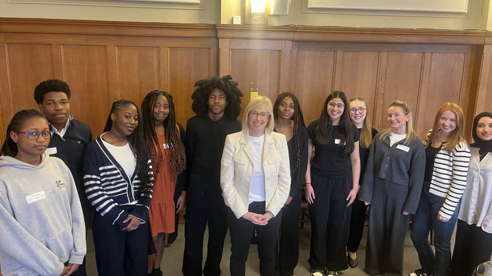 A group of students stand with Helen Bierton, centre