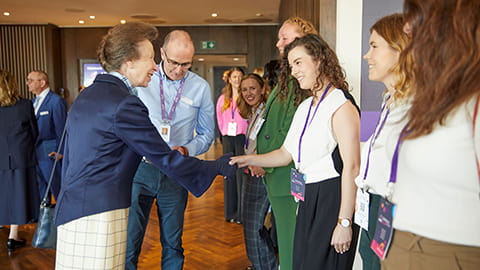 Lucy shakes hands with Princess Anne