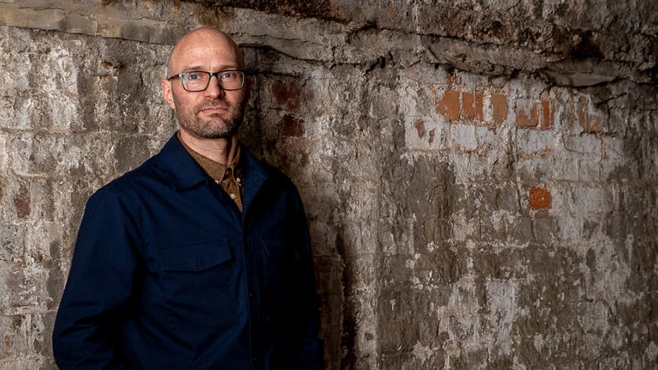 Nick Munn standing against a wall