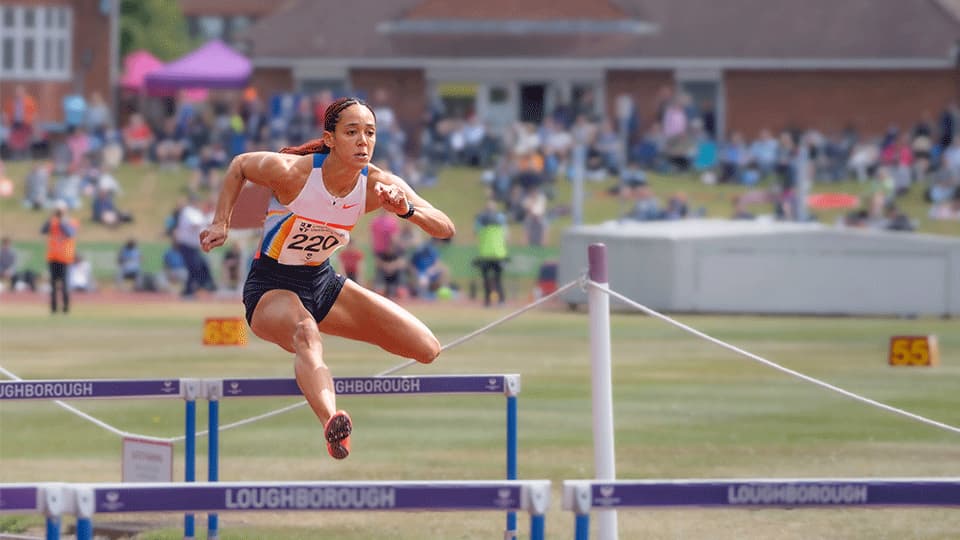 An athlete at Loughborough's International Athletics May 2025 jumping over a hurdle.