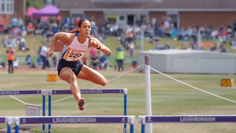 An athlete at Loughborough's International Athletics May 2025 jumping over a hurdle.