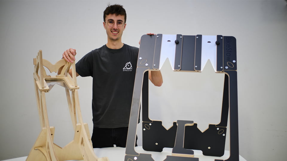 George Laight stands with the Bike Stow