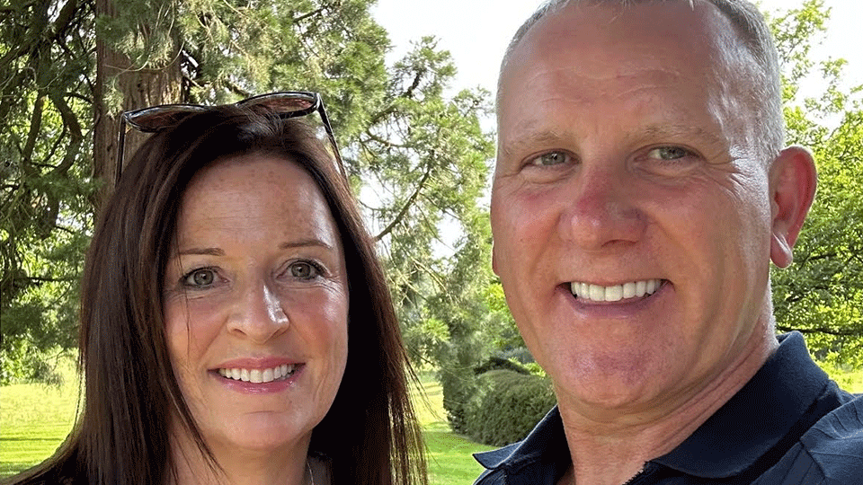 Martin Clay and Sharon Clay who are both Managing Directors of The Clay Advantage. They are standing together and they are smiling. There are trees in the background.