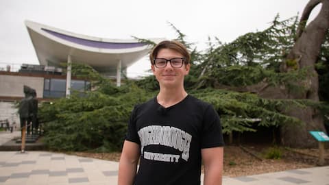 Student Vlad smiling outside EHB on campus