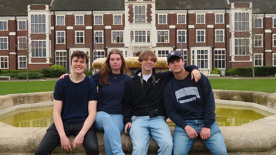 Team Tetra sit on the fountain outside Hazlerigg Building at Loughborough University