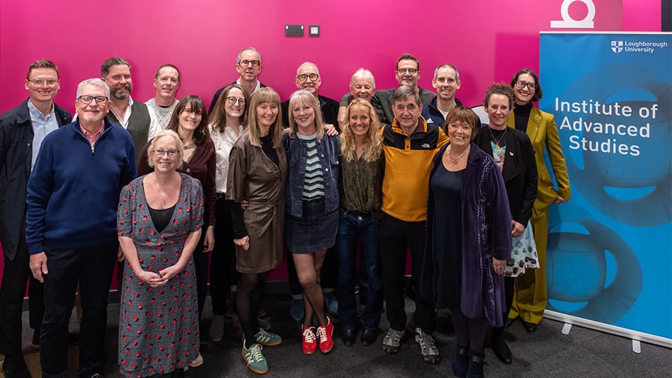 A group of people smiling, standing