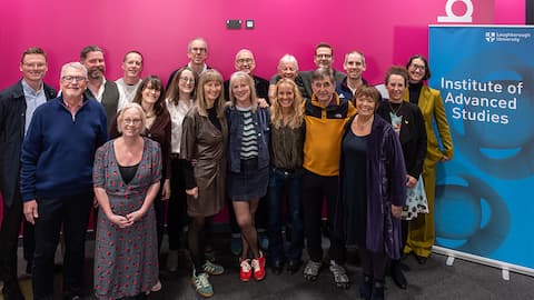 A group of people smiling, standing