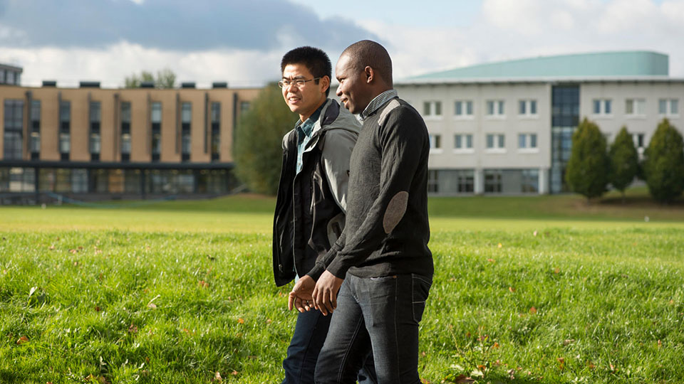 Two students walking near the Loughborough Business School at Loughborough University