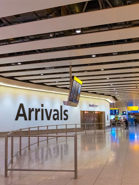 Heathrow airport arrivals sign on the wall