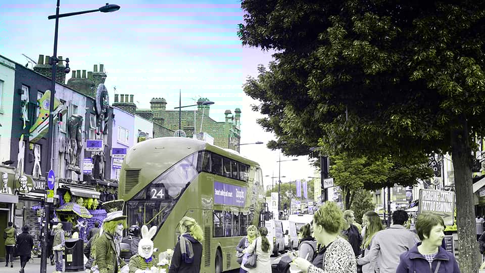 a crowded street with a red bus