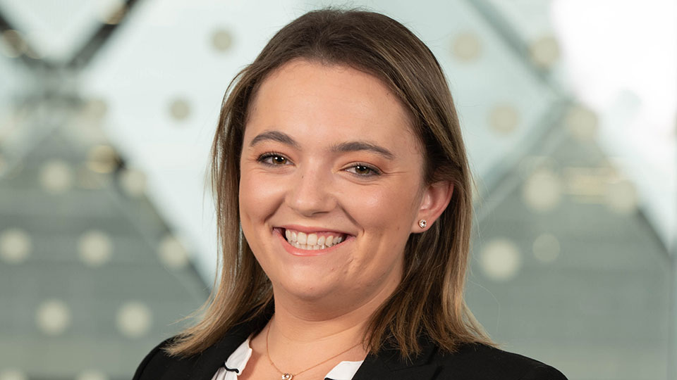 Caroline Sanborn smiling in front of the london campus