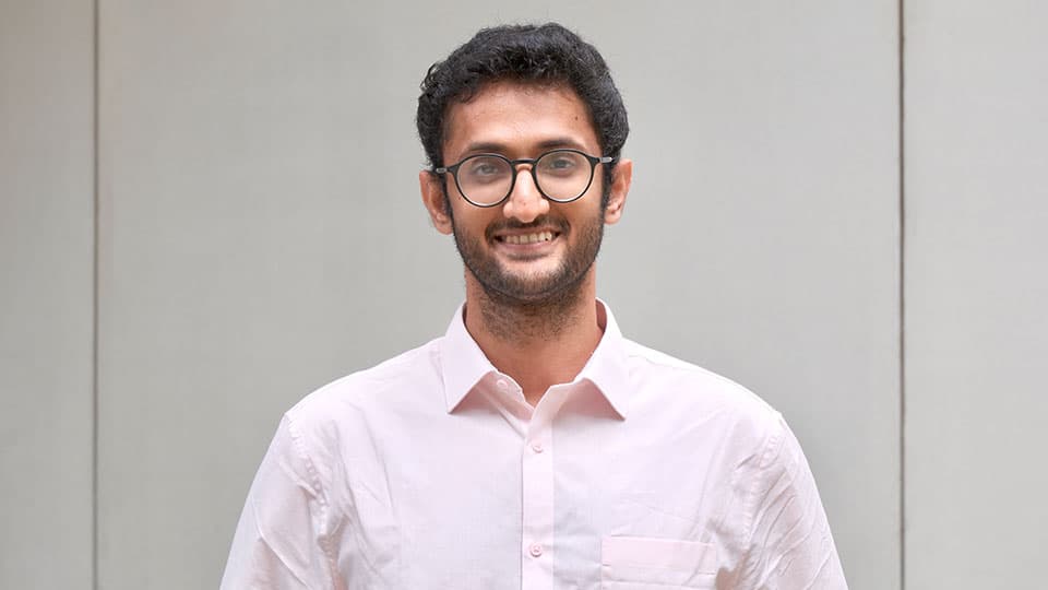 a photo of the alumni stood in front of a plain background