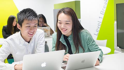 Two Loughborough University London students studying together