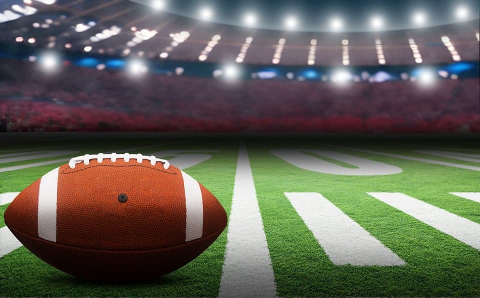 An American Football in a stadium with dramatic lighting