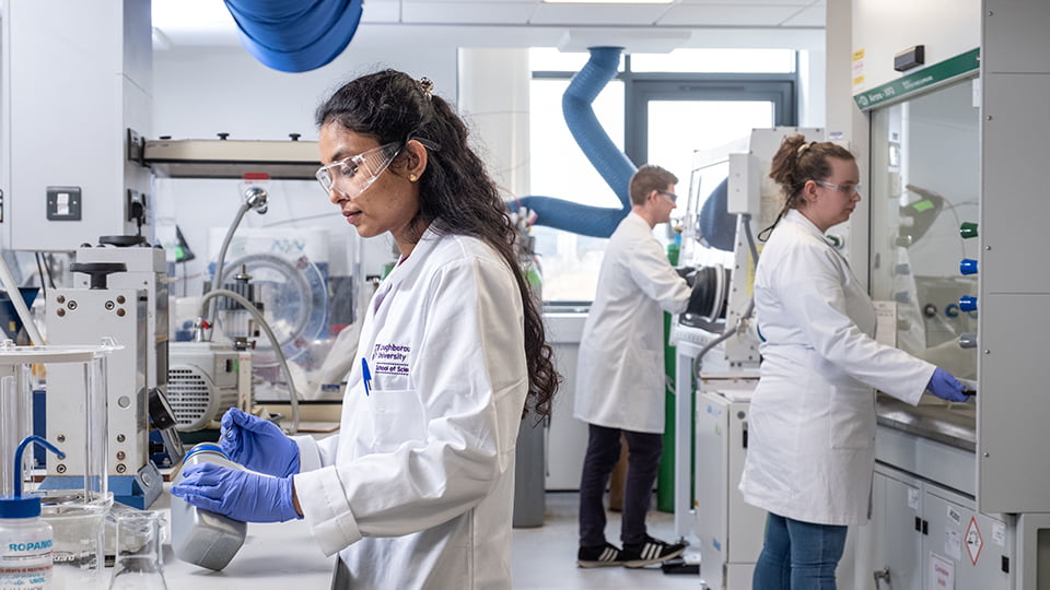 Students and staff working in an engineering lab
