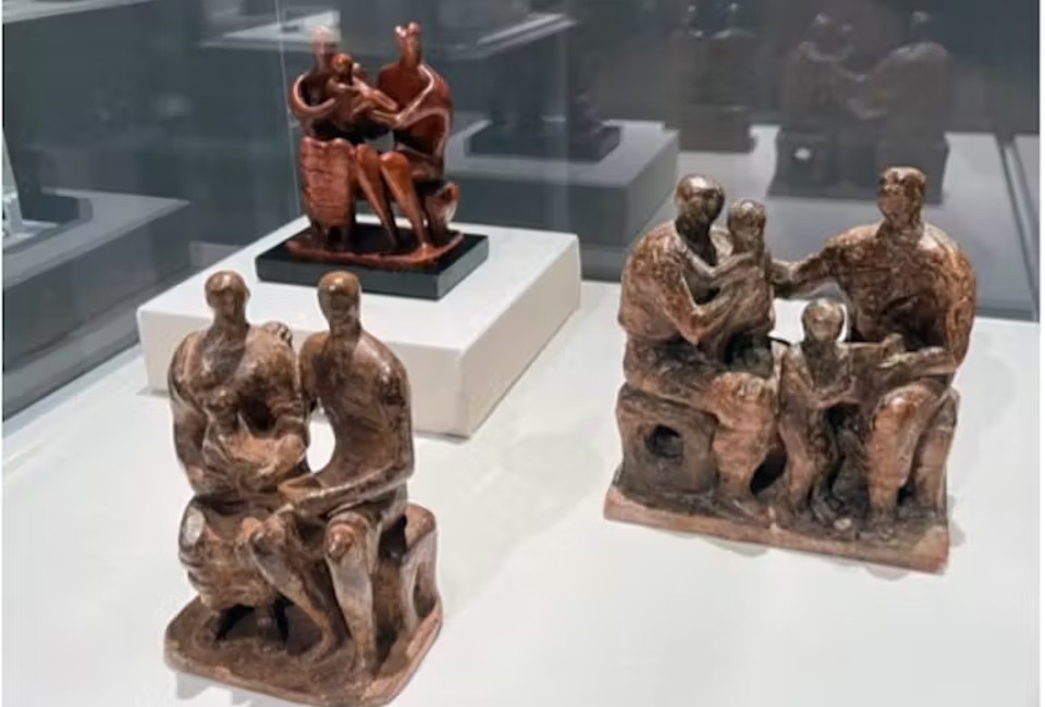 Picture shows three statues by Henry Moore. They are figures of different people. Titled: Family Group by Henry Moore, 1944-1945.