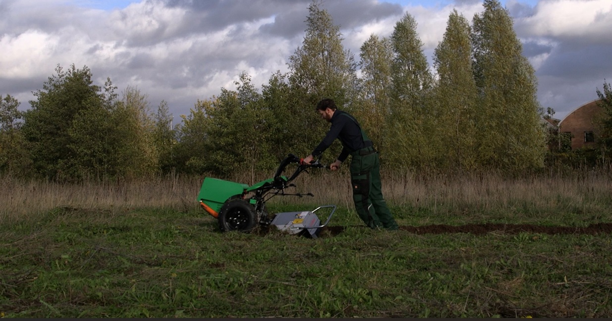 Man pushing aftrak tractor
