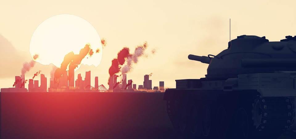 Building and rubble smoke in the distance as a tank stands aimed at them