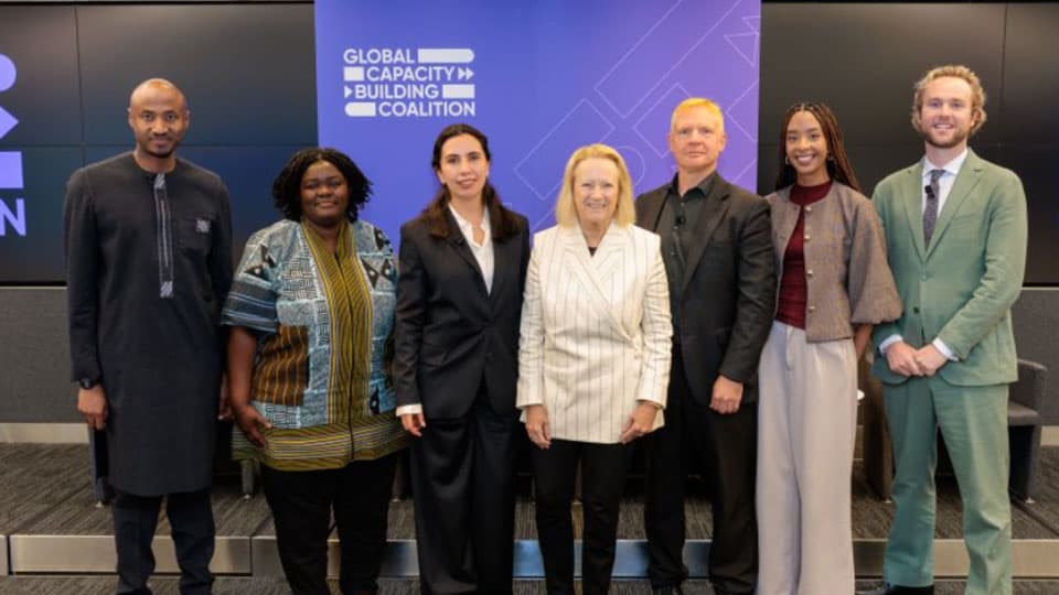 A group of people smiling at the camera at an event