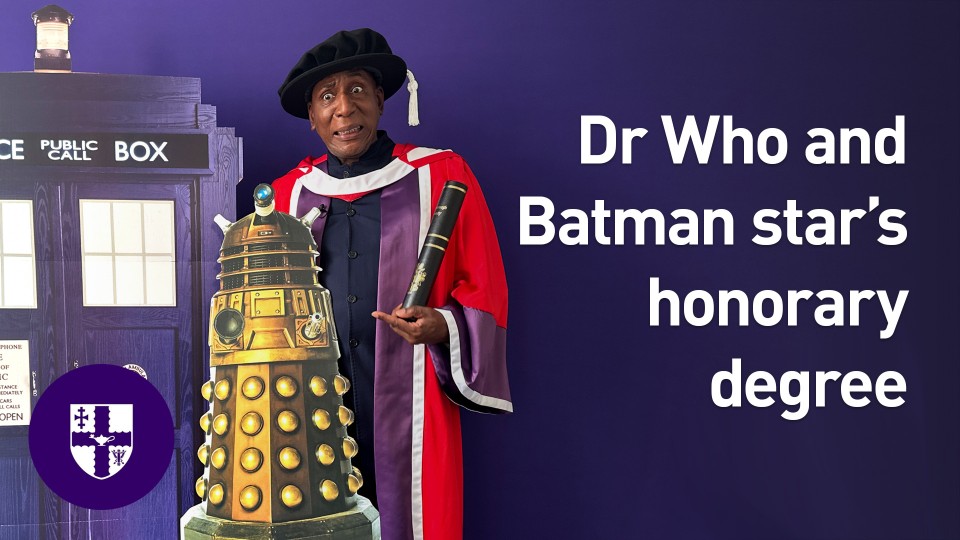 Colin McFarlane holding a Darlek stood next to a TARDIS