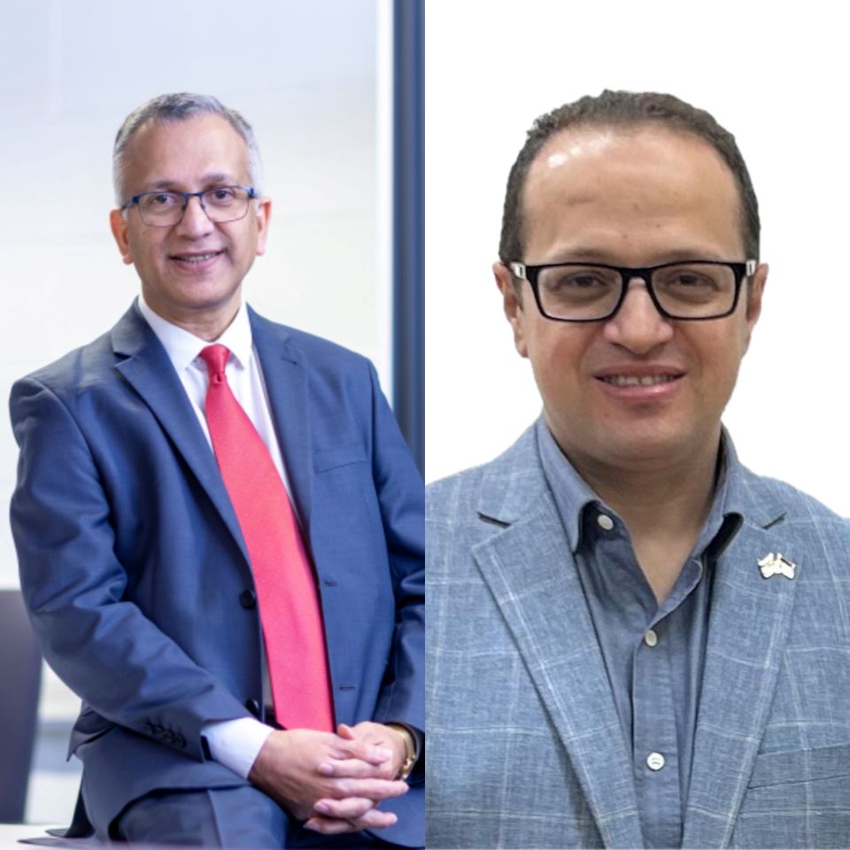 Professor Rajkumar Roy is sat in a blue suit with a red tie to the right of the image and Professor Moataz Attallah is pictured in a grey suit to the left of the image