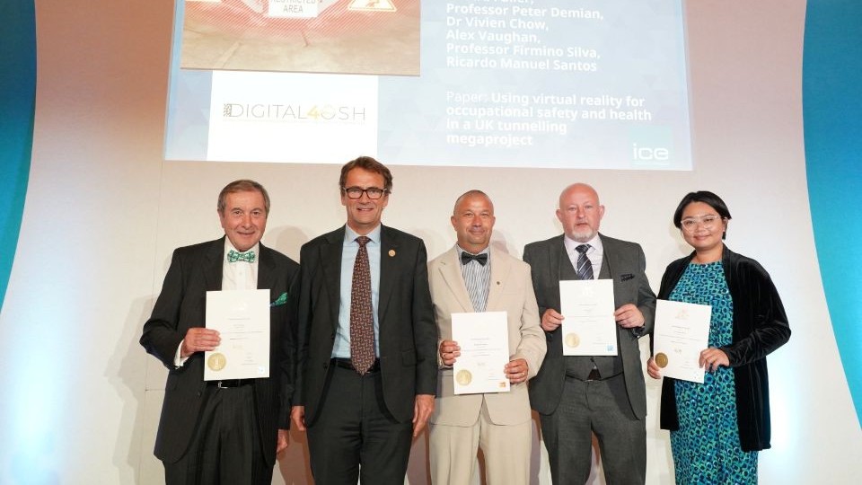 Pictured from the left on a stage are: Paul Fuller, Jim Hall, Manuel Tender, Alex Vaughan, Vivien Chow