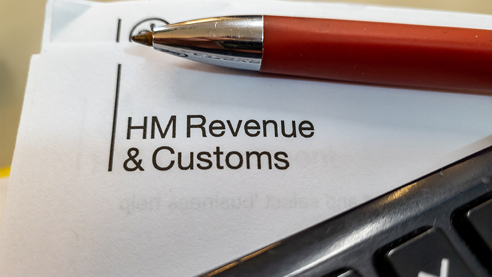 HMRC website and a pen and letter