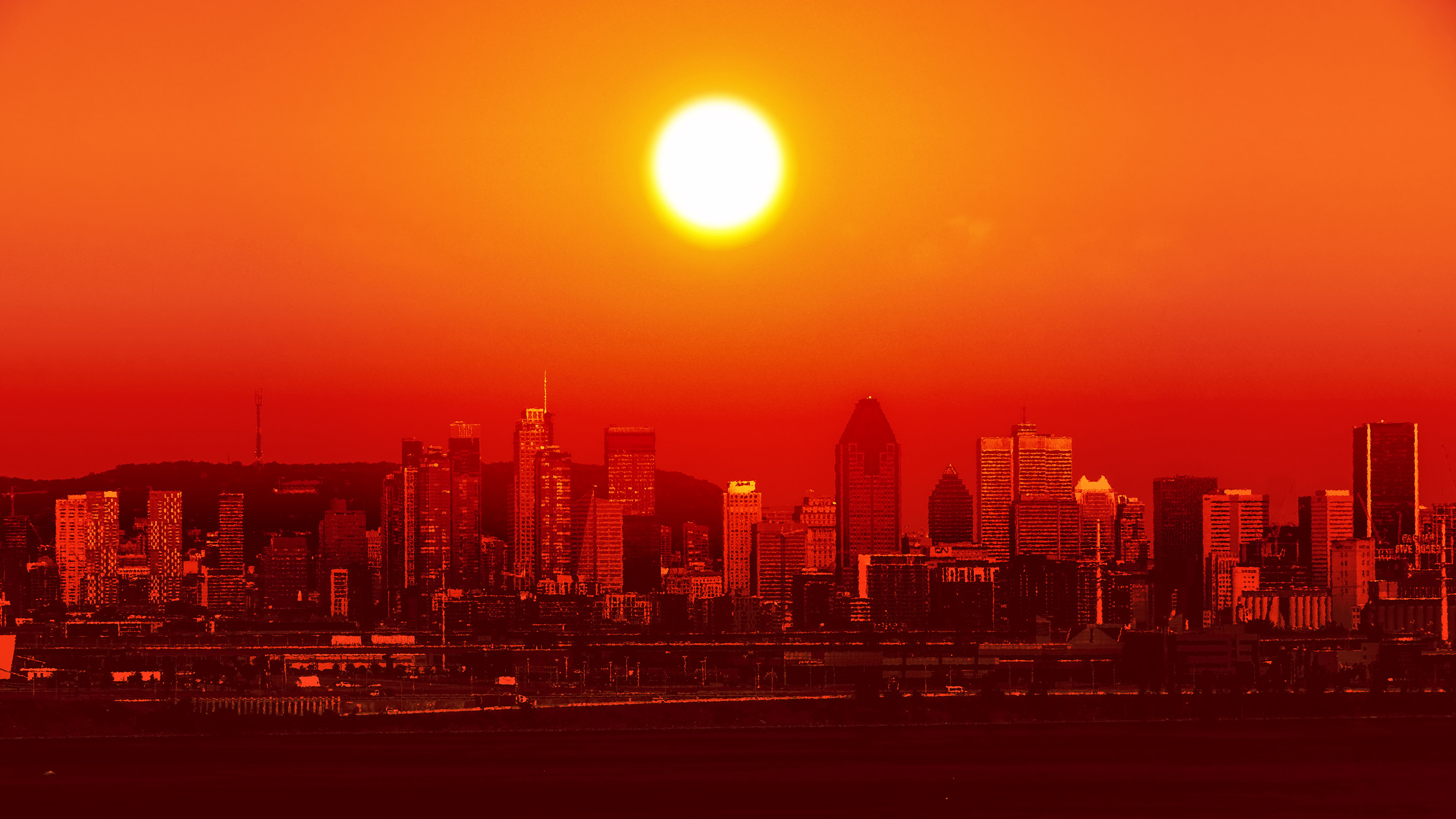 Sun rising during heatwave over city skyline