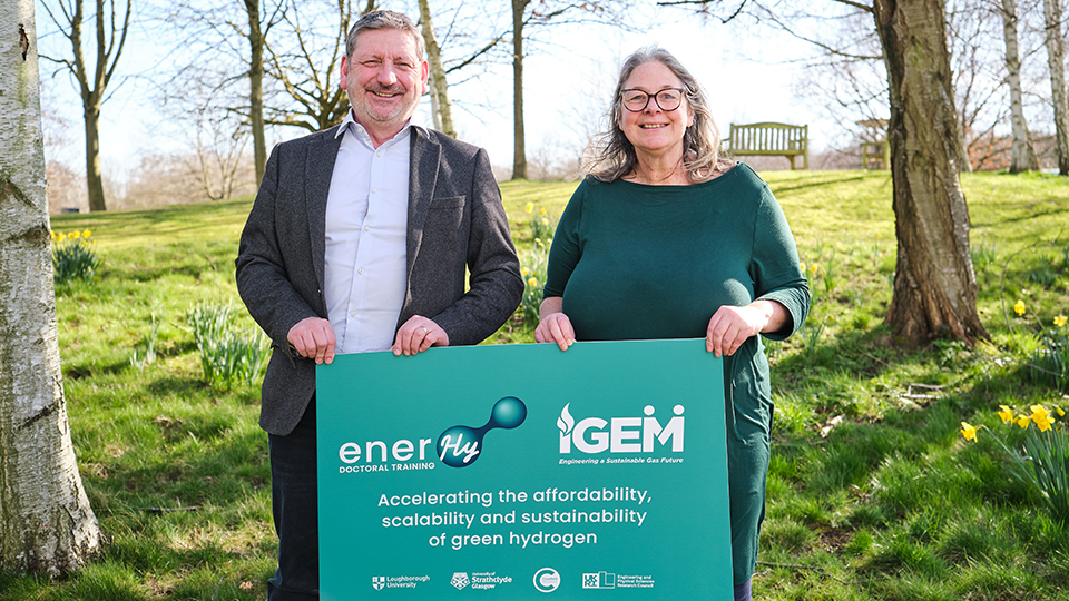 Representatives of IGEM and EnerHy stand together with partnership sign