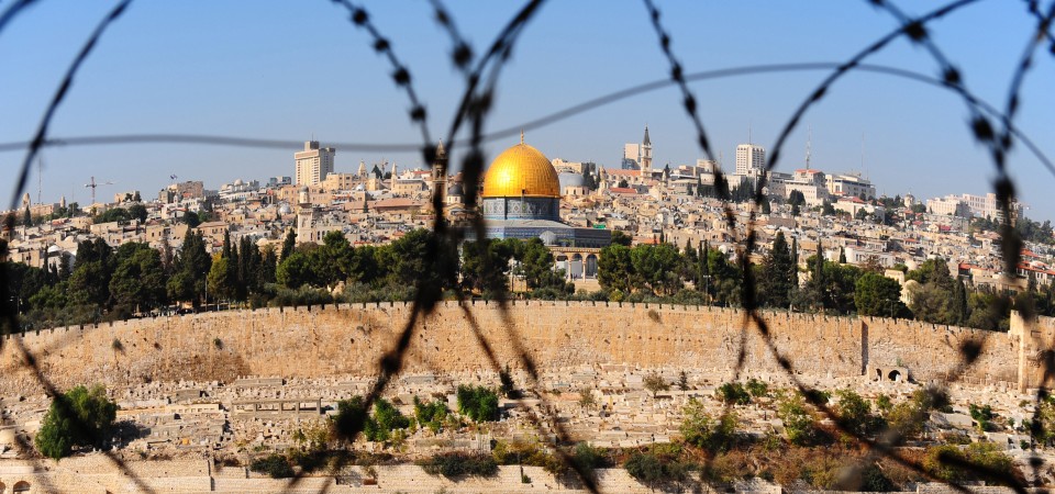 View from the Mount of Olives on the dome of the rock and ancient cemetery through the barbed wire, as a symbol of Palestine Israeli conflict