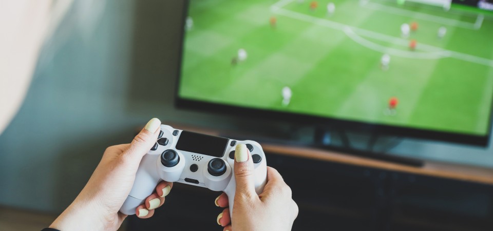 A person playing a football game on a games console