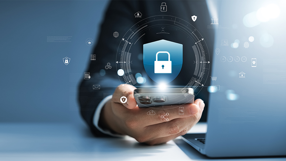 Hand holding phone with security graphics