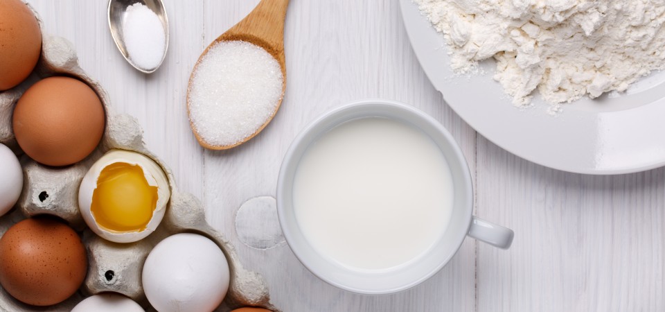 Ingredients for making pancakes. Flour, eggs, sugar and milk.