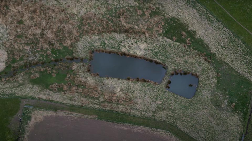An aerial shot of dual sediment ponds - two small ponds next to each other