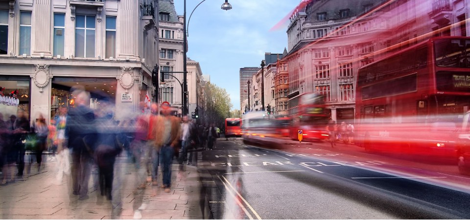 Busy Oxford Street in London including a red bus