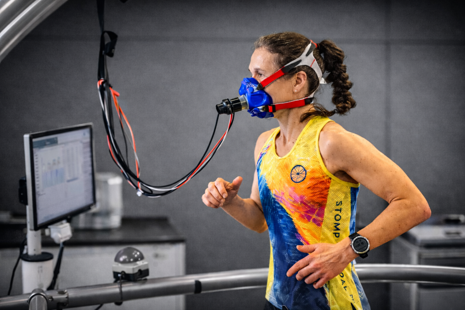 A woman is running on a treadmill with a face mask on taking part in some sports-related research
