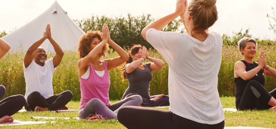 People at an outdoors yoga retreat