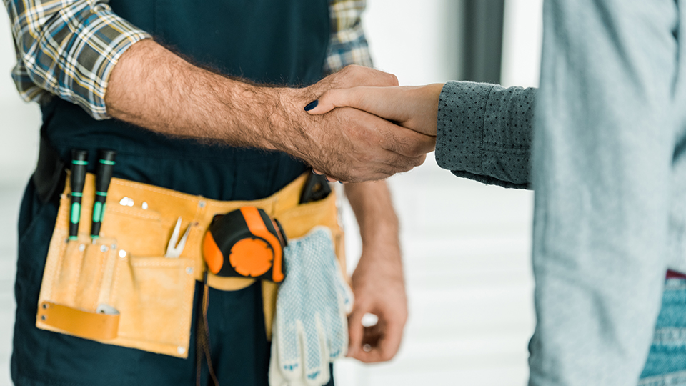 Tradesman shaking hands with customer