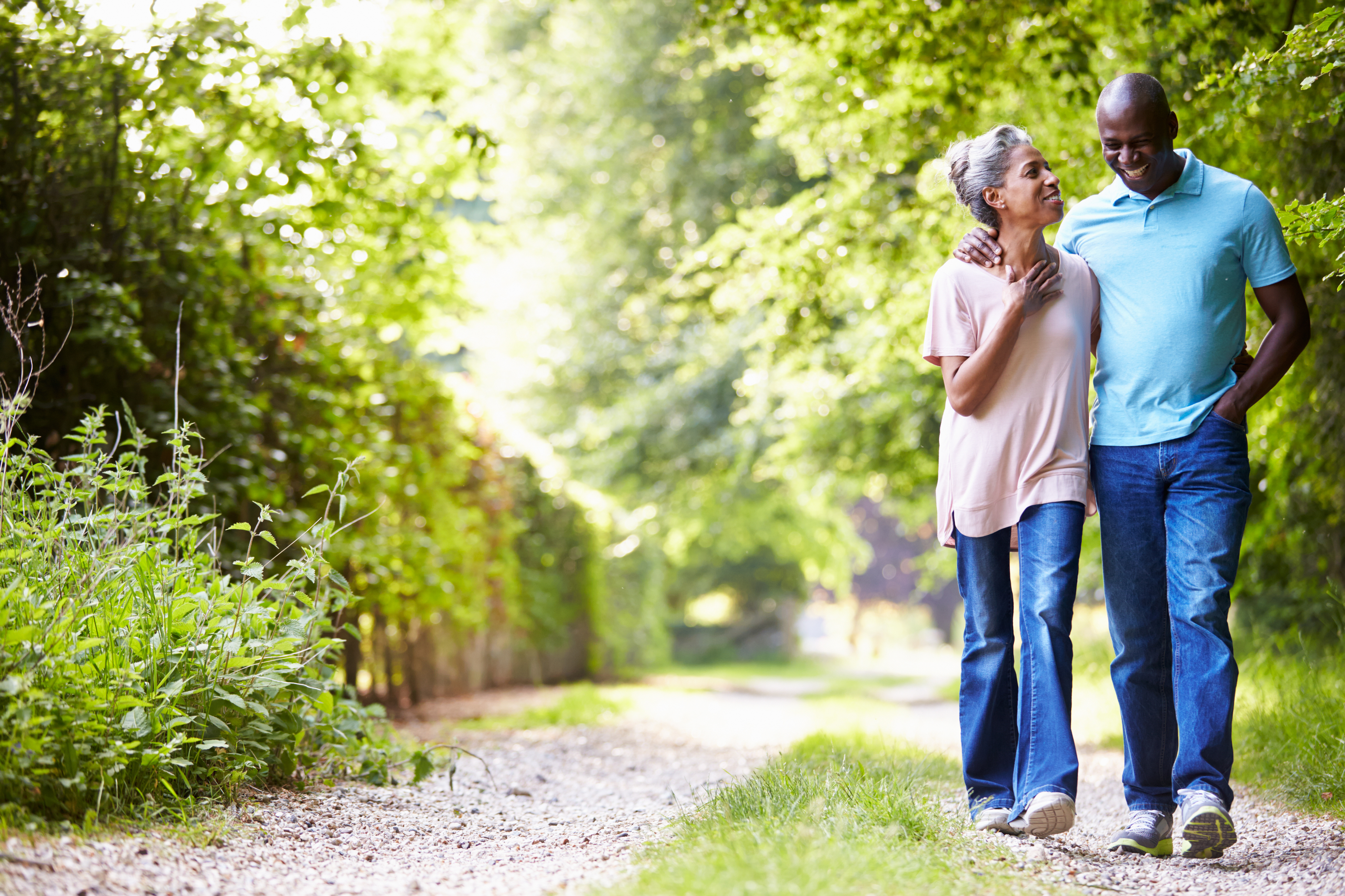 A middle aged couple walk in the countryside