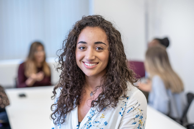 An intern smiles at the camera