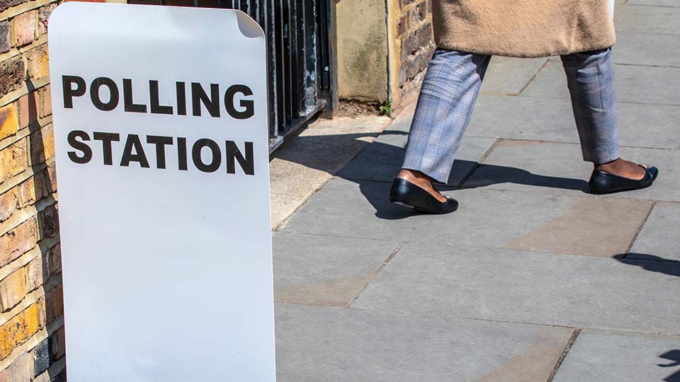 A woman walks out of a polling station