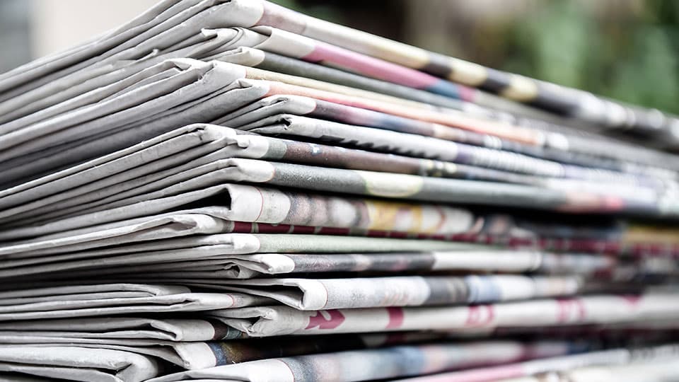 a close up of a stack of folded newspapers