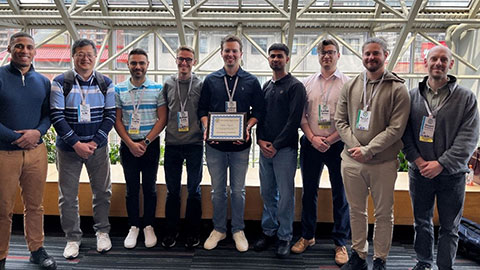 members of the CREST delegation at IEEE PVSC 2025 stood in a row
